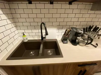 a kitchen counter with a sink in a kitchen at Central 2br Near Unveristy And Whyte Ave in Edmonton