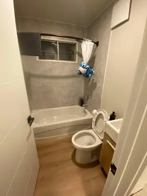 a bathroom with a toilet and a tub and a sink at Central 2br Near Unveristy And Whyte Ave in Edmonton