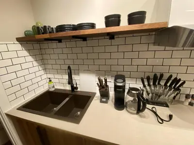 a kitchen counter with a sink and utensils at Brand New Modern Flat 2br1ba Whyte And University in Edmonton