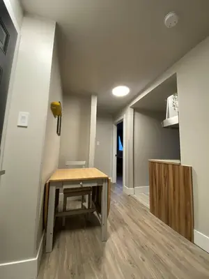 a small room with a table and a hallway at Brand New Modern Flat 2br1ba Whyte And University in Edmonton