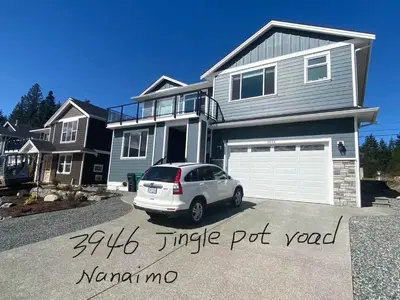 a white car parked in front of a house at \u6d77\u5c9b\u6c11\u5bbf 3\u5f20\u5e8a-2\u95f4\u5367\u5ba4\u72ec\u7acb\u5957\u623f in Nanaimo