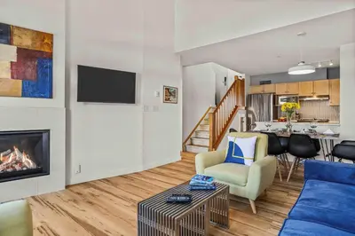 a living room with a couch and a fireplace at Freshly Remodeled - 2 King Beds- Breathtaking Views in Canmore
