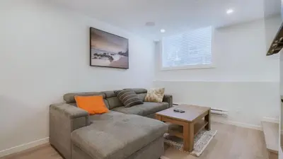 a living room with a couch and a table at Cozy place to stay in south Calgary in Calgary