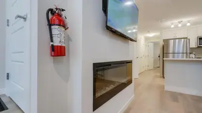 a fire extinguisher hanging on a wall in a kitchen at Cozy place to stay in south Calgary in Calgary
