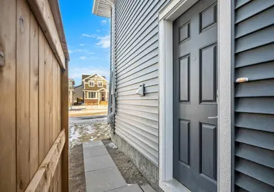 an open door to a house with a driveway at Mountain Hideaway Two Bedrooms Free Park Pass in Cochrane