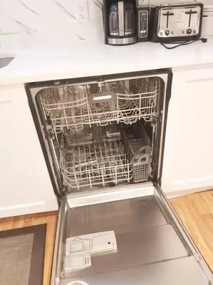 a dishwasher with its door open in a kitchen at Cozy suite, Free WIFI , Free Parking in Calgary