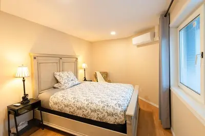 a small bedroom with a bed and a window at Beaver Beach Vacation Home in Madeira Park