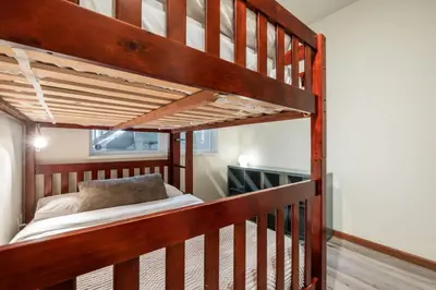 a loft bed in a room with a bunk bed at Deer Run by Outpost Whistler in Whistler