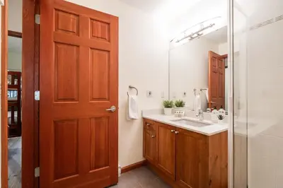 a bathroom with a sink and a mirror at Deer Run by Outpost Whistler in Whistler