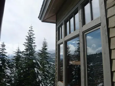 a window with a view of a snowy mountain at Whistler Ski In Ski Out in Whistler