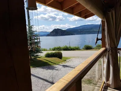 a view of a lake from a house window at West facing Waterfront Cottage with private beach & buoy & dock access in Blind Bay