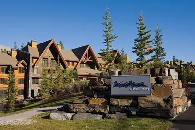 a sign on a stone wall in front of a house at Worldmark Canmore Banff Alberta Canada in Canmore