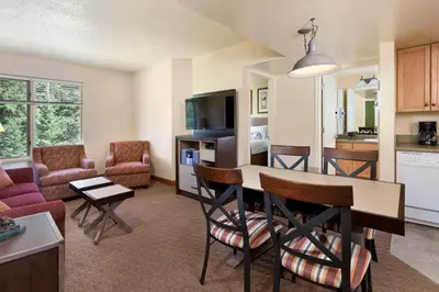 a living room with a kitchen and a dining room at 2 Bd Worldmark Canmore Banff Condo in Canmore