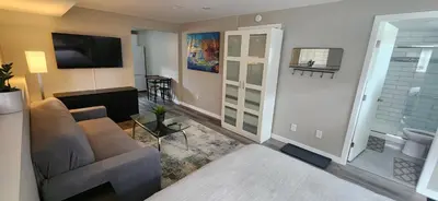 a living room with a couch and a television at The Bainbridge Studio in Burnaby