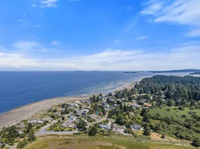an aerial view of a beach with houses and the ocean at A Seaside Jacuzzi Escape in Parksville, BC, Canada in Parksville