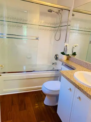 a bathroom with a toilet and a tub and a sink at Richmond Garden Retreat in Richmond