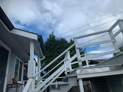 a white staircase on the side of a house at Exclusive Offer - A special deal ending soon!! Super Nice Location - Very close to YVR Airport and shopping center & easy transportation in Vancouver