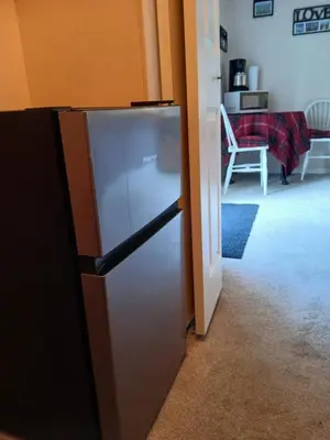a refrigerator in a room with a living room at Serenity Bed and Breakfast in Comox