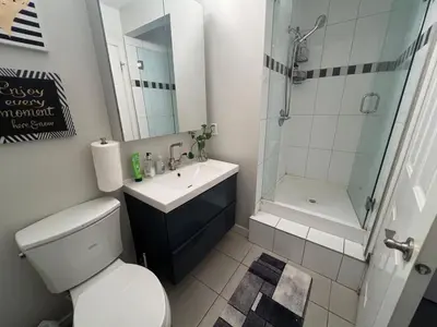 a bathroom with a toilet and a sink and a shower at Vancouver airport 7mins away joy room in Richmond