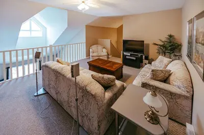 a living room with a couch and a television at Peaks of Radium by StayIn in Radium Hot Springs