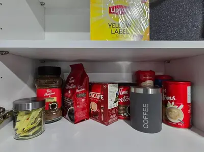 a shelf in a refrigerator with various food items at Cozy New 1 bed basement suite in Edmonton