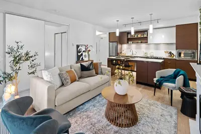 a living room with a couch and a kitchen at Your Own Private Oasis In Victoria in Victoria