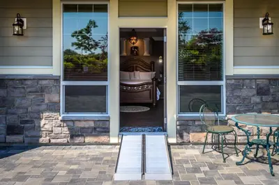 a front door of a house with a table and chairs at Brookside Inn Boutique Hotel in Abbotsford