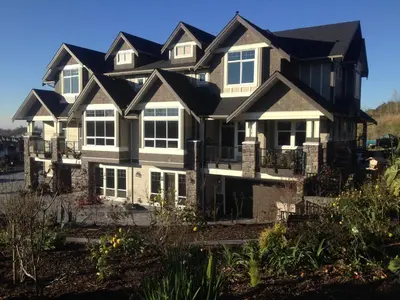 a large house with a black roof at Brookside Inn Boutique Hotel in Abbotsford