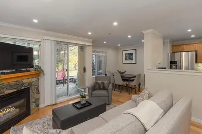 a living room with a couch and a fireplace at 1BR in Sunpath, Epic Village Location, Private Patio, Pool and Hot Tub, Parking in Whistler