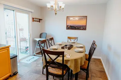 a dining room with a table and some chairs at Central Calgary & Nearby Mountain Escape - 4 Beds in Calgary