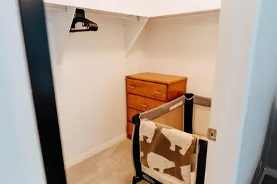 a room with a dresser and a chair in a room at Central Calgary & Nearby Mountain Escape - 4 Beds in Calgary