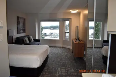 a hotel room with a bed and a television at High Pont Resort in Quathiaski Cove