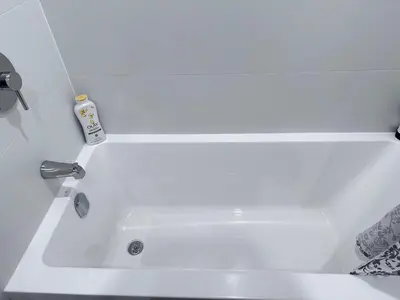 a white bath tub with a faucet in a bathroom at New condo near Lougheed Mall & SFU in Coquitlam