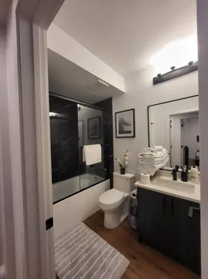 a bathroom with a toilet and a sink at Pebbles' Cozy 2Bed Basement Suite - near Downtown in Edmonton