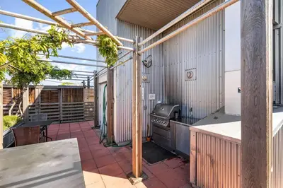 an outdoor patio with a grill and a table at Water Views From Every Window in Victoria