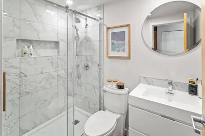 a bathroom with a shower and a toilet and a sink at Water Views From Every Window in Victoria