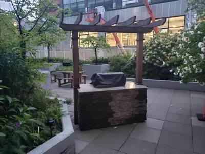 a pergola with a bench in a garden at New York Style Loft in Downtown Vancouver-Ideal for World Cup 2026, Sleeps 4 in Vancouver