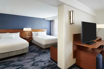 a hotel room with two beds and a flat screen tv at Fairfield Inn & Suites by Marriott Calgary Downtown in Calgary