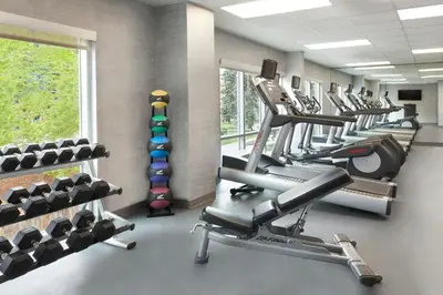 a gym with a row of treadmills and machines at Fairfield Inn & Suites by Marriott Calgary Downtown in Calgary