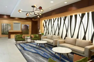a lobby with couches and tables on a rug at Fairfield Inn & Suites by Marriott Calgary Downtown in Calgary