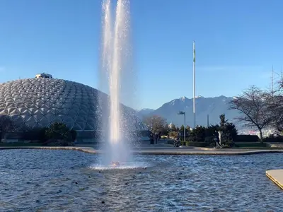 a fountain in front of a large glass building at 7 Bedrooms in the Heart of Vancouver in Vancouver