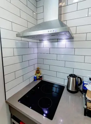 a kitchen with a stove top in a kitchen at LuxQuarters Bumbleberry Guest House in Kitimat