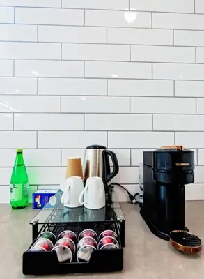 a tray of cups and a coffee maker on a counter at LuxQuarters Huckleberry Suite in Kitimat