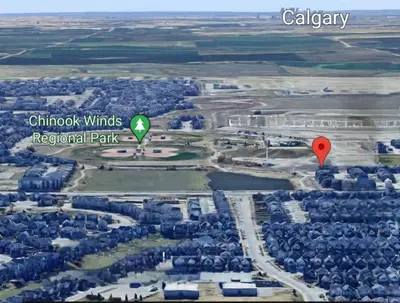two hot air balloons flying over a city at Serenity&Luxury Redefined - A waterfront adventure in Airdrie