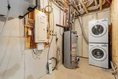 a laundry room with a washer and a washing machine at Serenity&Luxury Redefined - A waterfront adventure in Airdrie