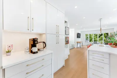 a kitchen with white cabinets and a white counter top at Riley Park-Modern 4 Bedroom Home, Central location in Vancouver