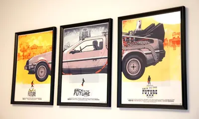 a group of four posters hanging on a wall at Riley Park-Modern 4 Bedroom Home, Central location in Vancouver