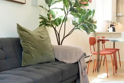 a couch with a pillow on it in a living room at Riley Park-Modern 4 Bedroom Home, Central location in Vancouver