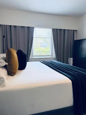 a bedroom with a bed with pillows and a window at Modern King Room Private Ensuite Vancouver West in Vancouver