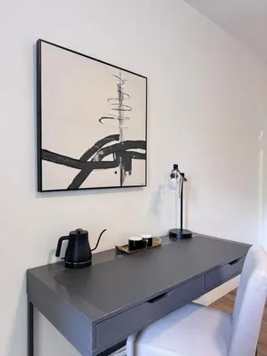 a gray desk with a lamp and a chair at Modern King Room Private Ensuite Vancouver West in Vancouver